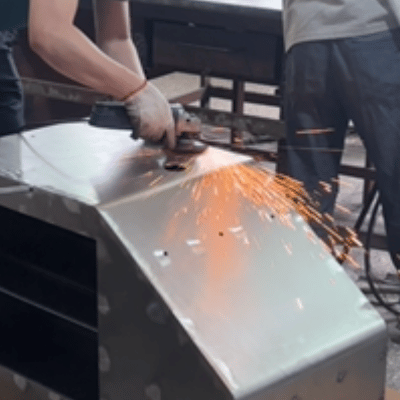 Precision laser cutting metal for custom POP displays at Goldmak factory.